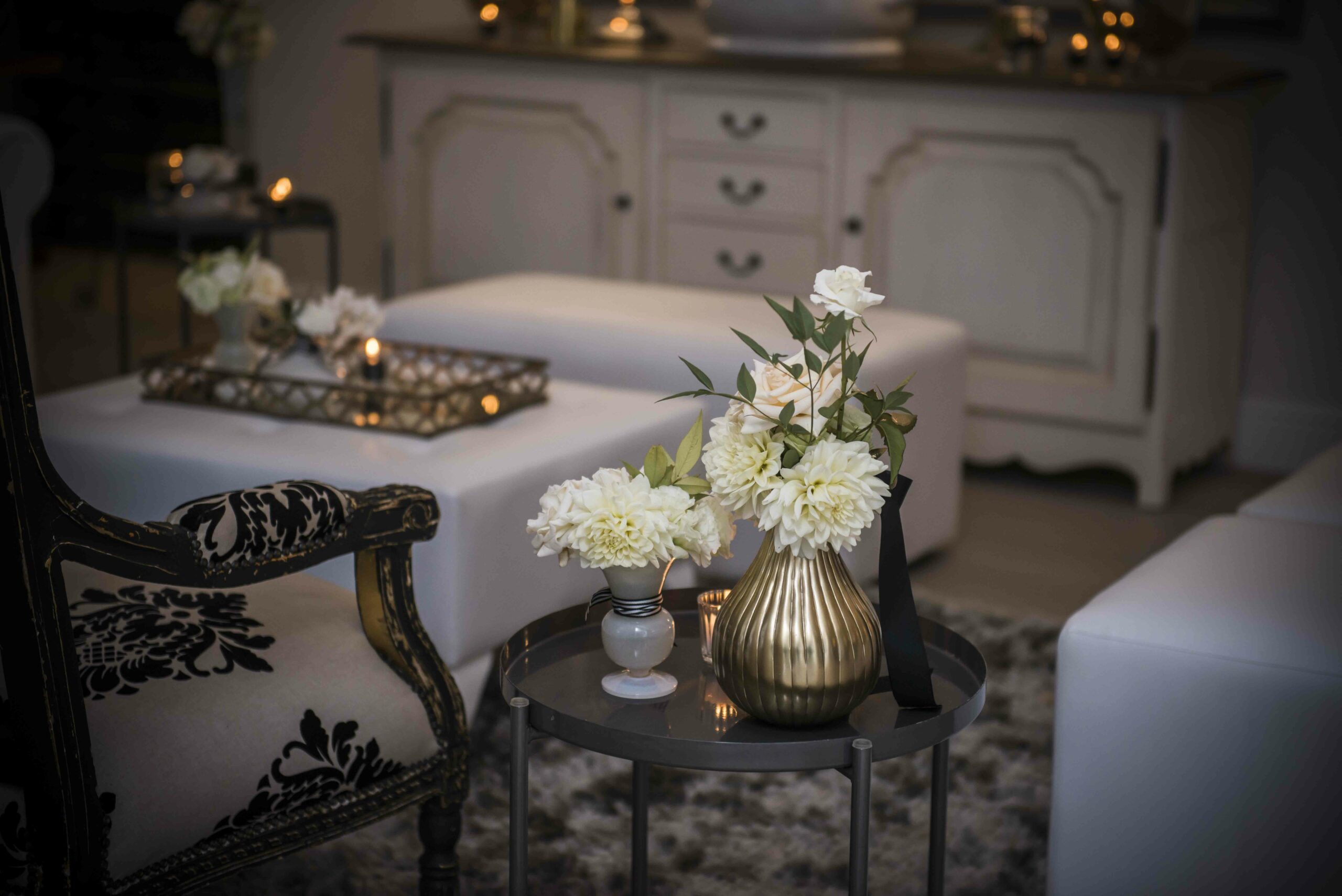 Wooden dinner table with candles and dried flower arrangement