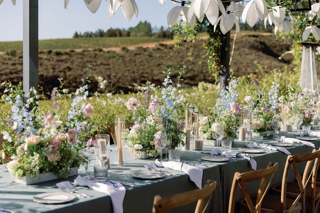 Outdoor wedding reception table with pastel flowers